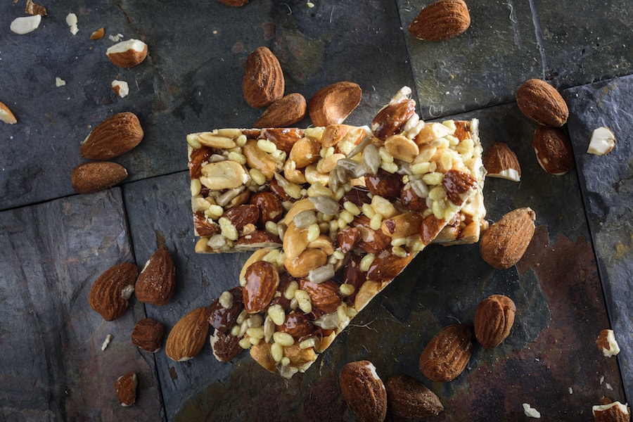 Two almond bars  and almonds | DNAfit Blog 