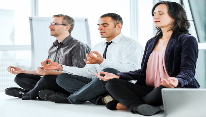 Colleagues doing yoga | DNAfit Blog